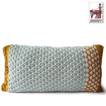 a crocheted pillow with yellow and white trim on the front, sitting against a white background