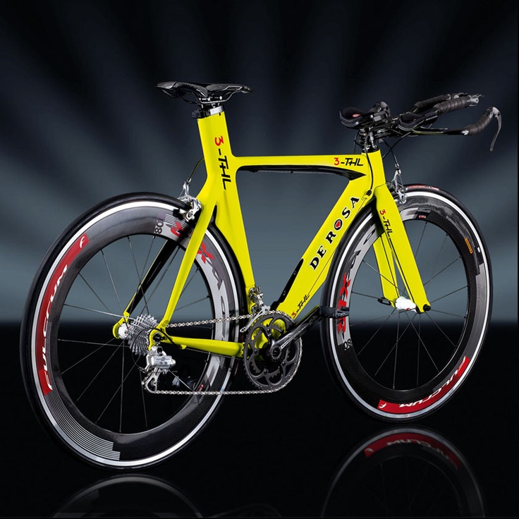 a yellow bike with red rims on it's front and rear wheels, against a black background