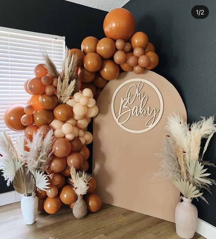 balloons and flowers are on display in front of a sign