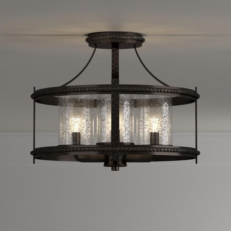 a chandelier with three lights hanging from the ceiling