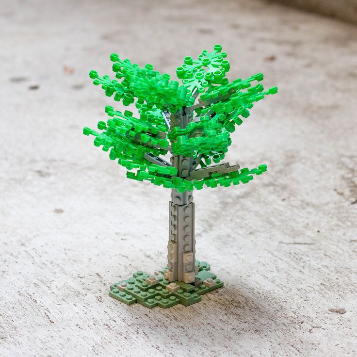 a small tree made out of legos on the ground