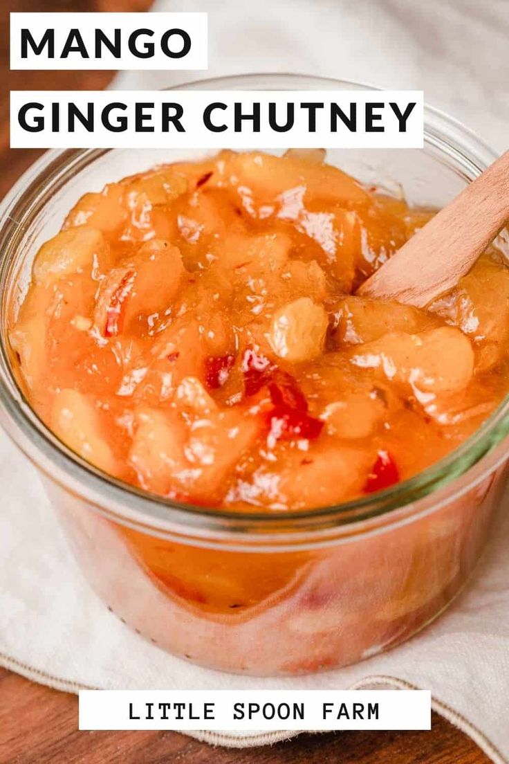 mango ginger chutney in a glass bowl with a wooden spoon on the side