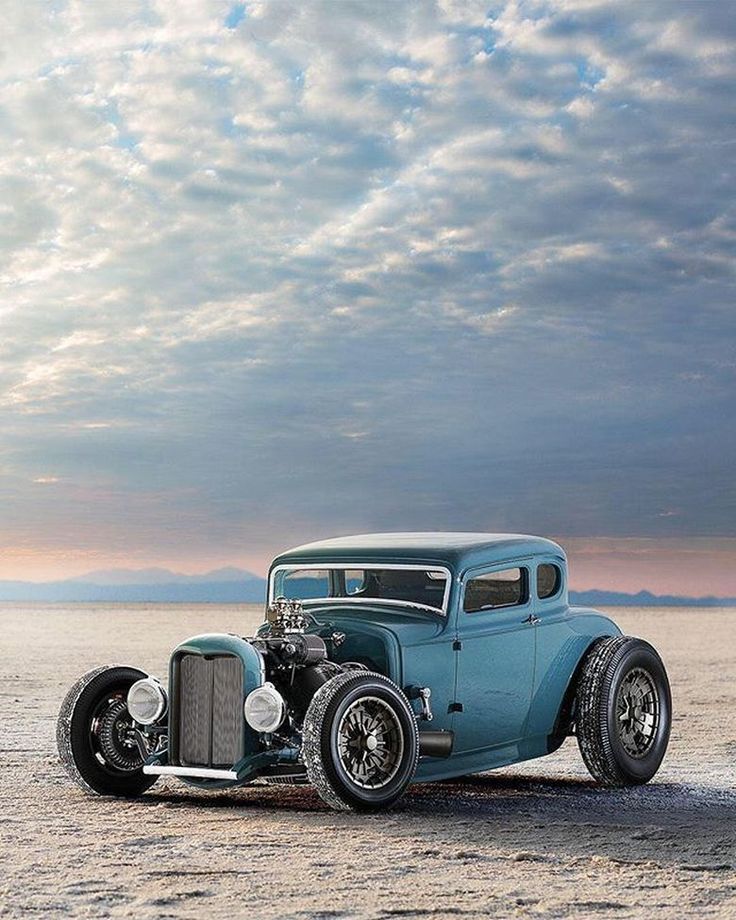 an old fashion car is parked in the desert