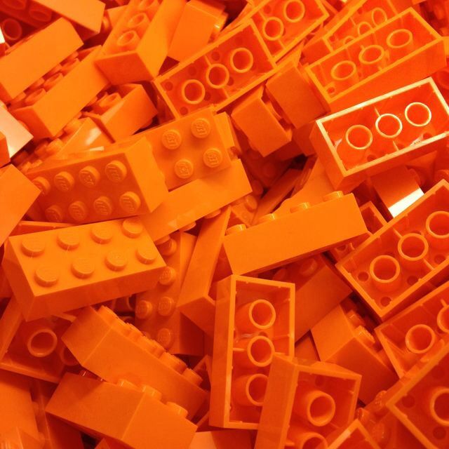 a pile of orange legos sitting next to each other