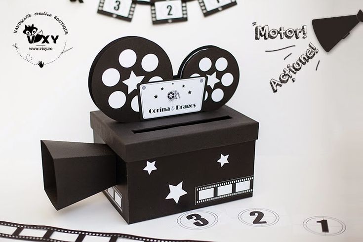 a black and white photo of a box with a film reel on it's side