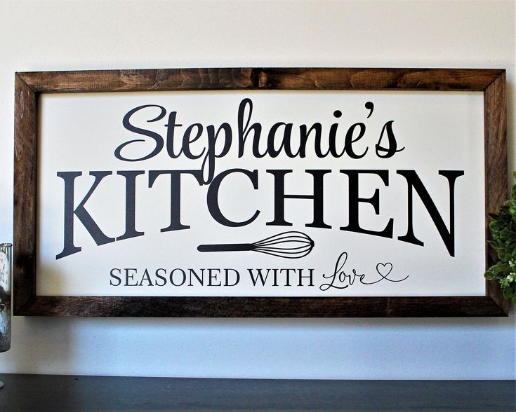 a sign that says stephanie's kitchen seasoned with love on the wall above a shelf