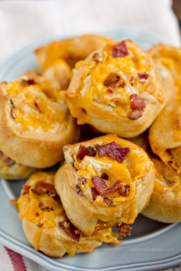 a plate filled with mini bacon and cheese muffins