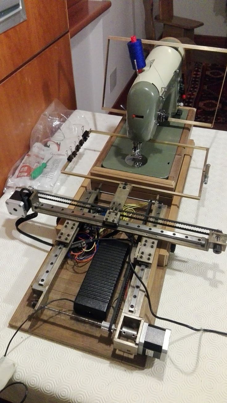 a machine is sitting on top of a table with wires and other items around it