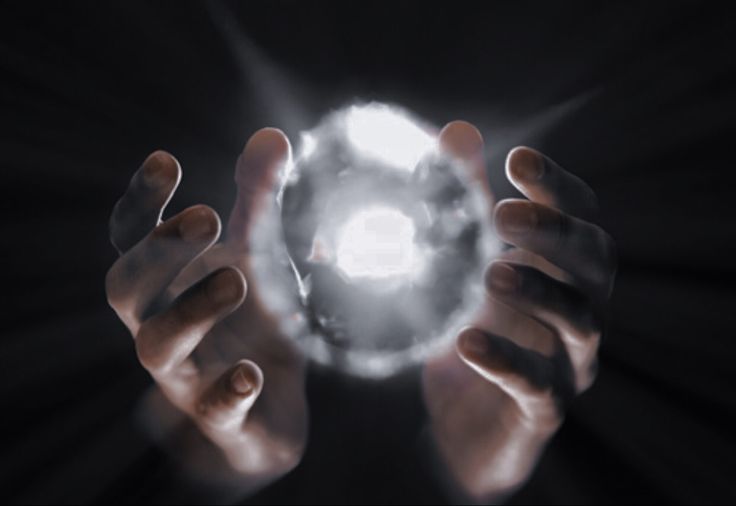 two hands holding a light ball in the middle of their palms, with one hand reaching for it