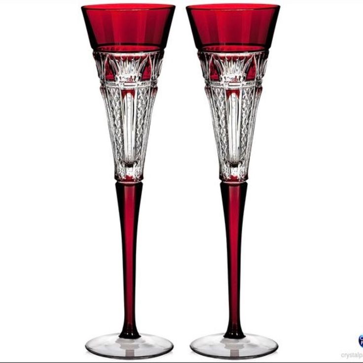 two red wine glasses sitting next to each other