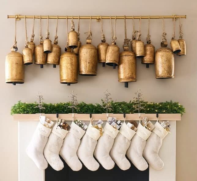 christmas stockings hanging on a mantle with bells