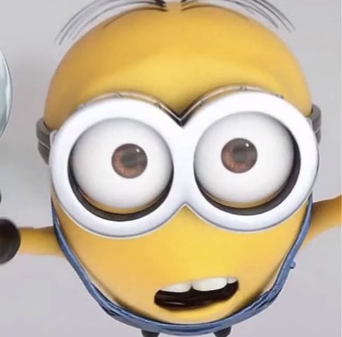 a yellow minion with big eyes is holding his arms out and looking at the camera