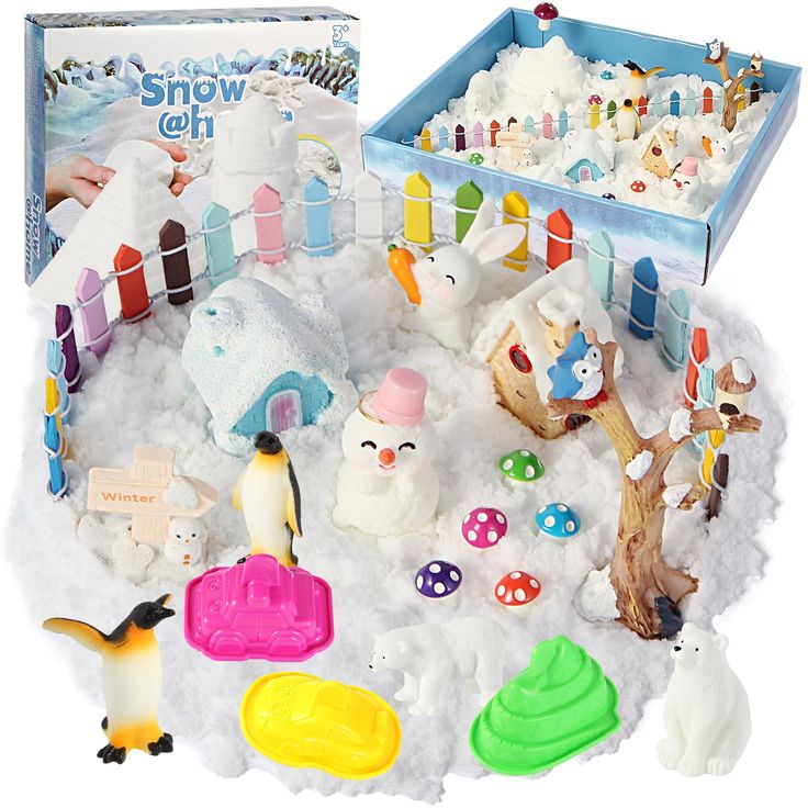 an assortment of toy animals and toys in the snow next to a play set that is made out of plastic