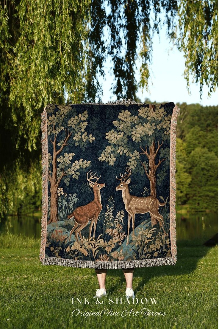 an image of a deer tapestry hanging in the grass