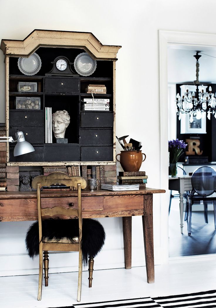 a room with a desk, chair and bookshelf