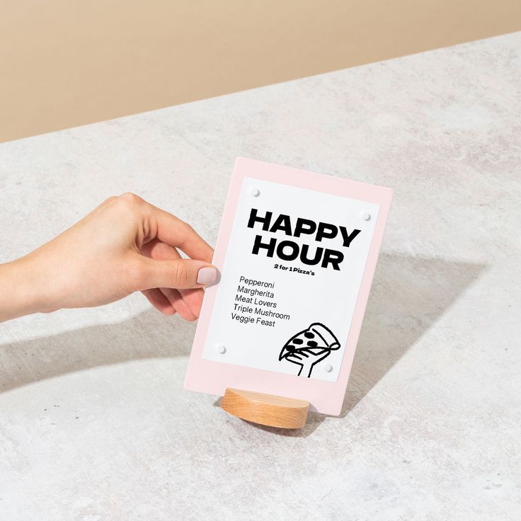 a hand holding a sign that says happy hour on the front and back of it