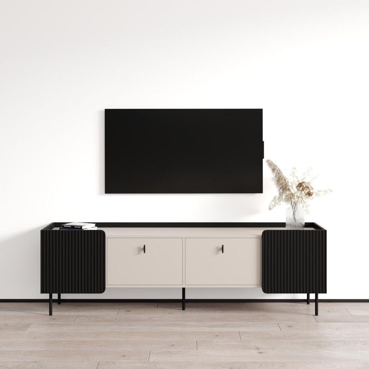 an entertainment center with a large flat screen tv mounted on it's sideboard