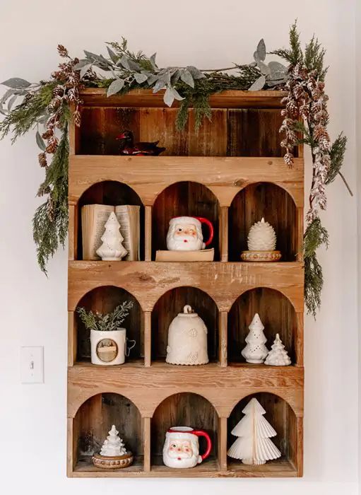 a wooden shelf with christmas decorations on it