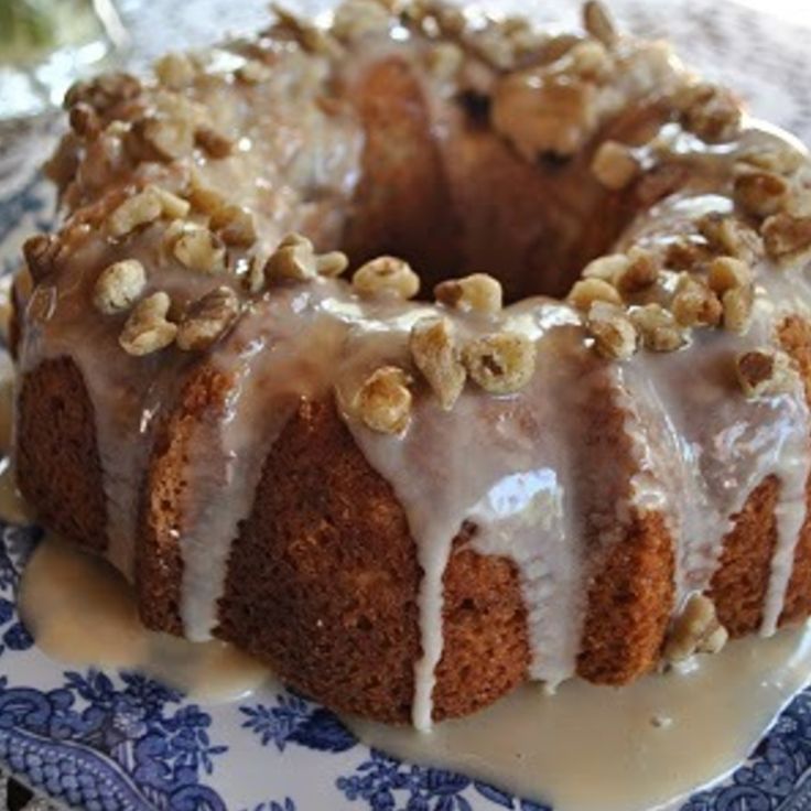 a bundt cake on a blue and white plate with icing drizzled