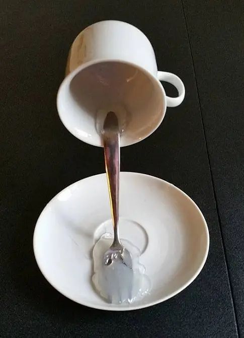 the spoon is pouring water into two plates