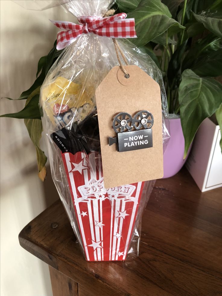 a basket filled with food sitting on top of a wooden table next to a potted plant