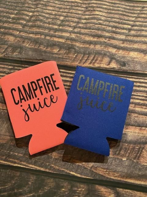 two campfire juice coasters sitting on top of a wooden table next to each other