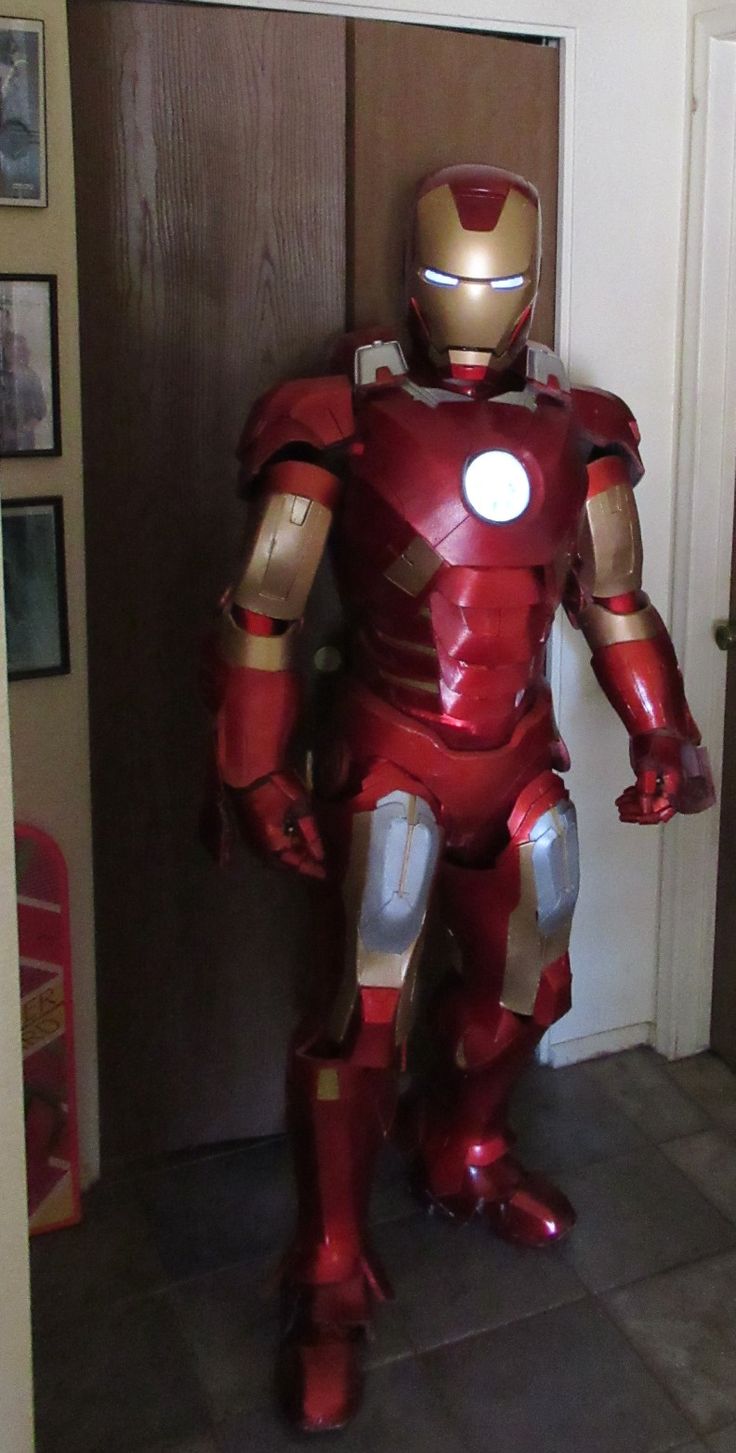 an iron man costume is standing in front of a door