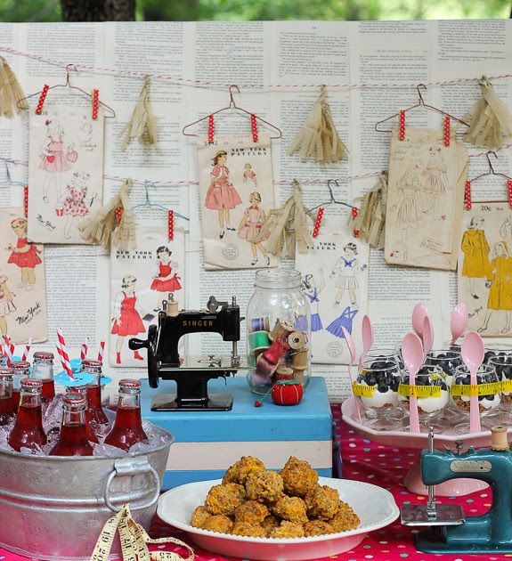 a table topped with lots of food next to a wall covered in pictures and papers