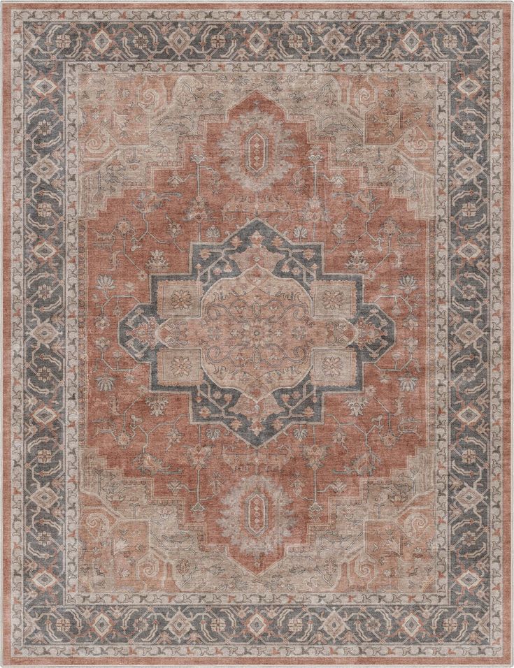 an orange and gray area rug with ornate designs on the center, in various colors