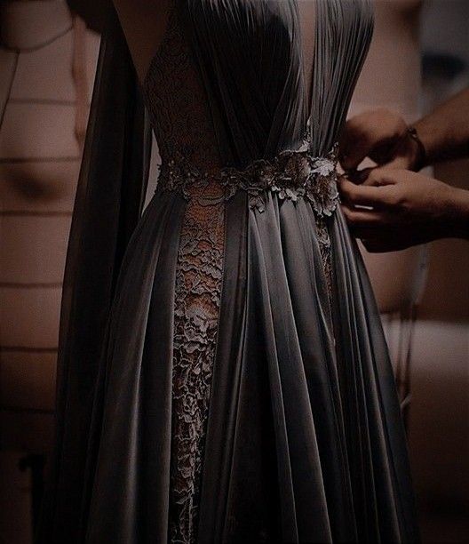 a woman is wearing a dress with an elaborate belt