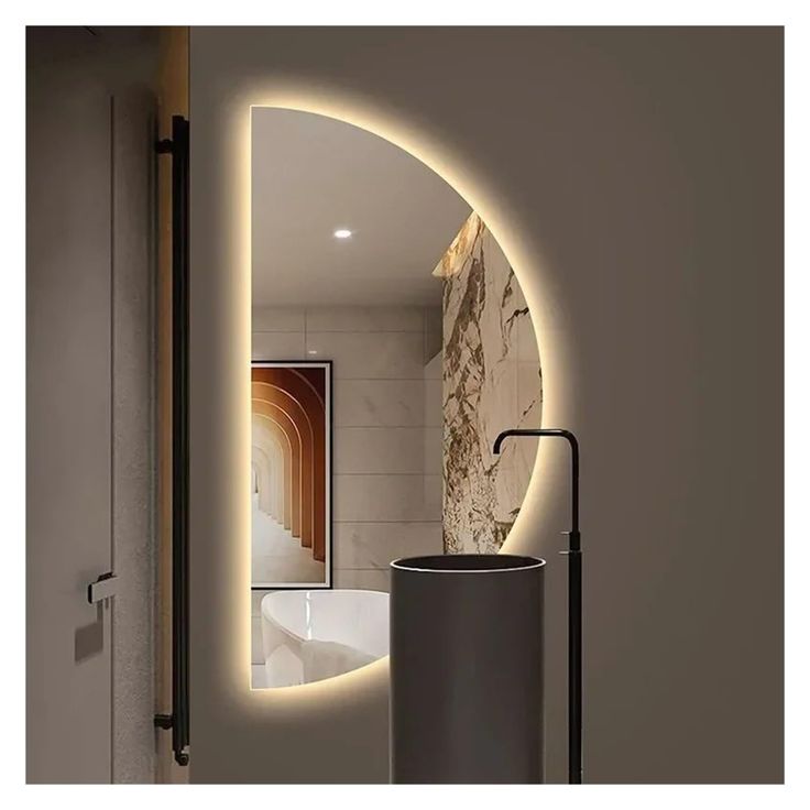 a bathroom with a round mirror and light on the wall, along with a sink