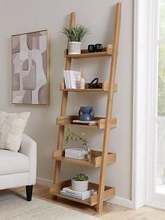 a living room with a white couch and wooden shelves on the wall next to a window