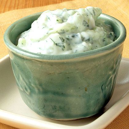 a green bowl filled with food on top of a white plate