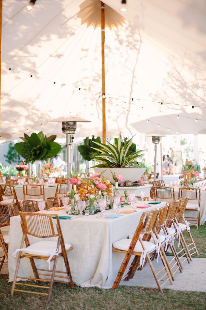 the tables are set up with white linens and wooden chairs for an outdoor wedding reception