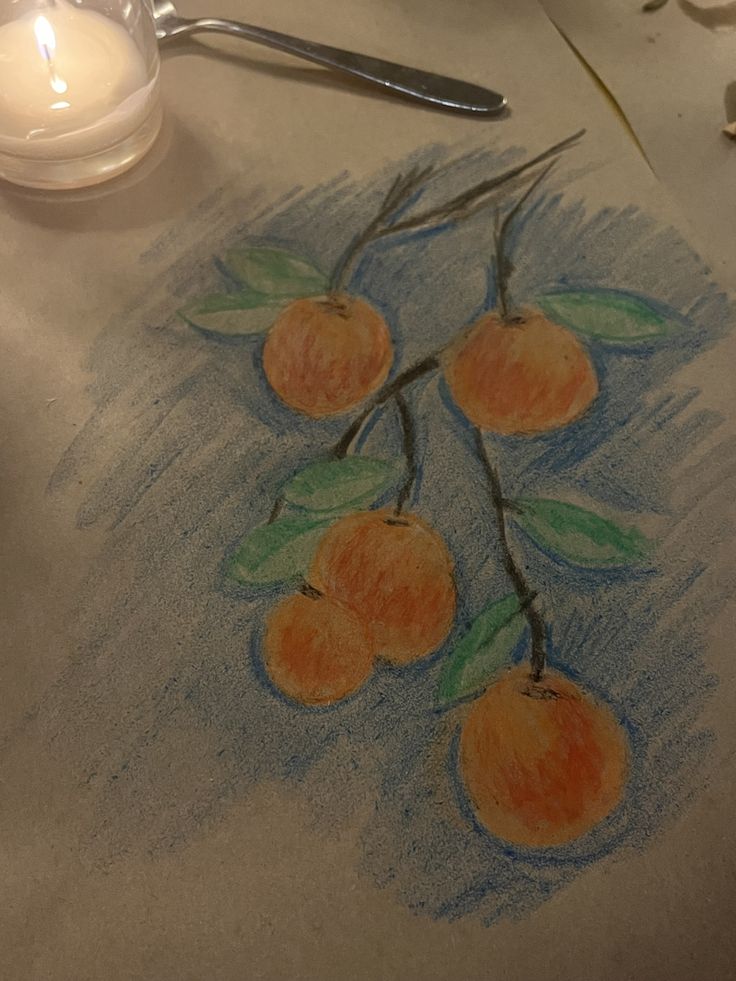 a drawing of three oranges on a table next to a candle and some scissors