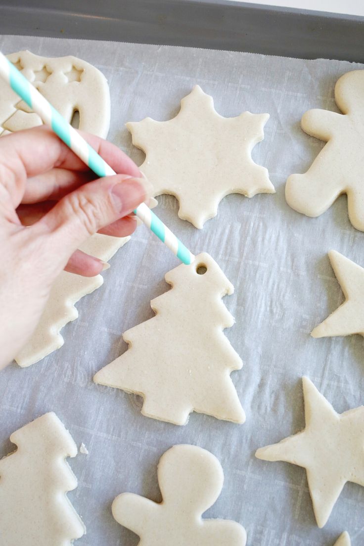 someone is decorating christmas cookies with icing