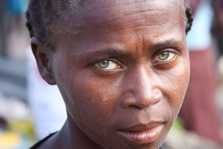 a close up of a person with green eyes