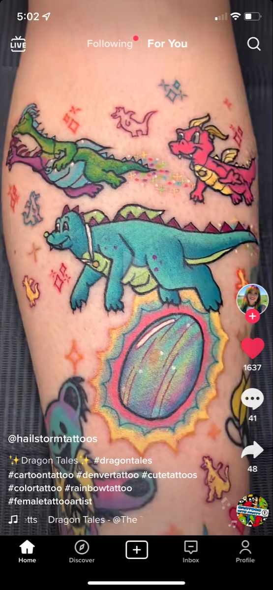 an image of a tattoo on someone's leg with dinosaurs and stars around it