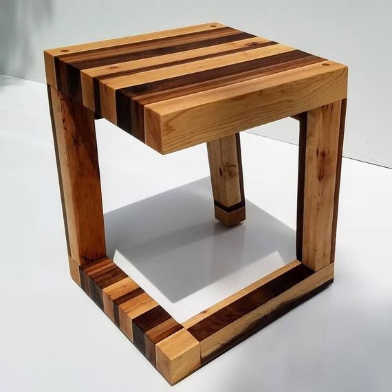 a small wooden table sitting on top of a white floor