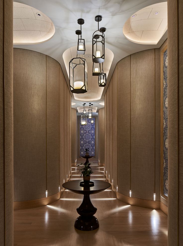 an elegant hallway with chandeliers and lamps