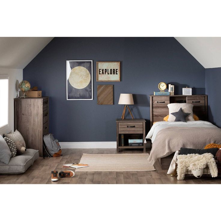 a bedroom with blue walls and wooden furniture