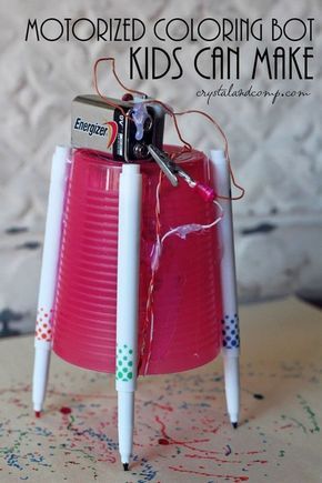 a pink cup with two pens sticking out of it and the words motorized coloring bot kids can make