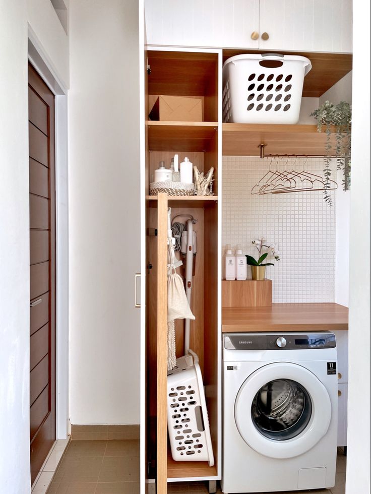 a washer and dryer sitting in a room next to each other on shelves