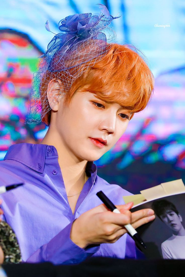 a woman with red hair is reading a book