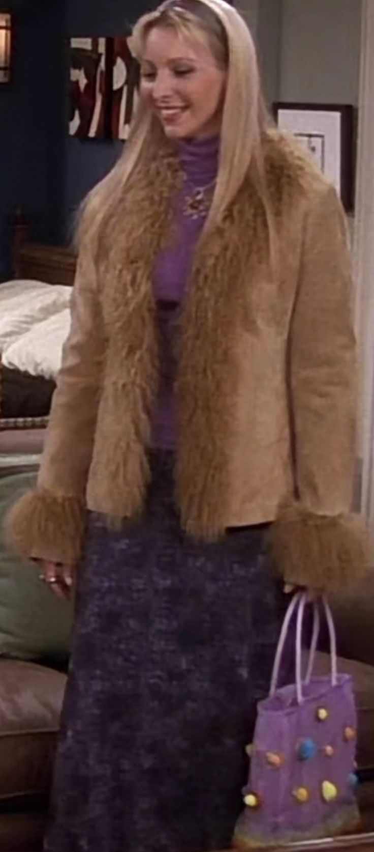 a woman holding a purple bag in her hand and wearing a brown fur coat on top of it