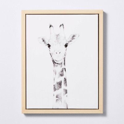 a black and white photo of a giraffe's head in a frame