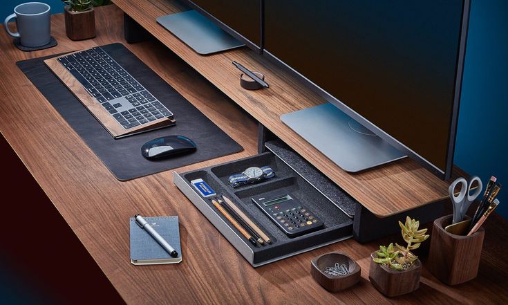 a desk with a keyboard, mouse and other items on it