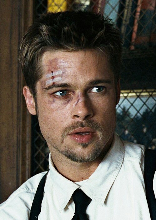 a close up of a person wearing a shirt and tie with paint on his face