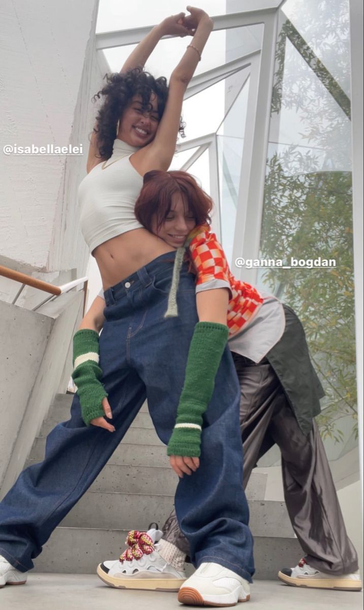 two women in overalls are posing for the camera with their arms around each other