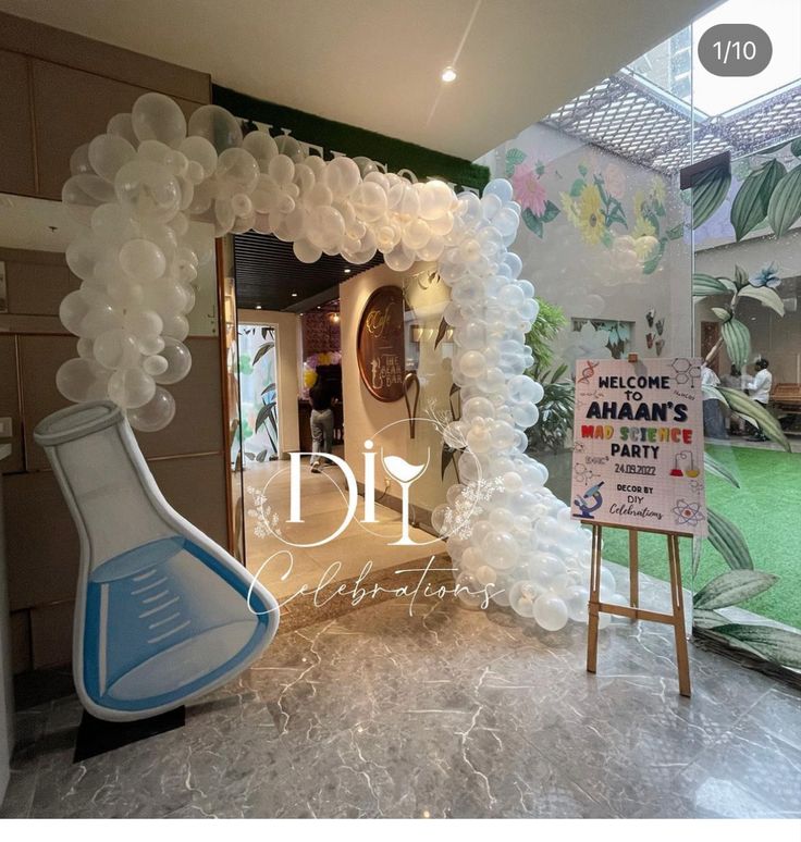 an entrance decorated with balloons and flowers